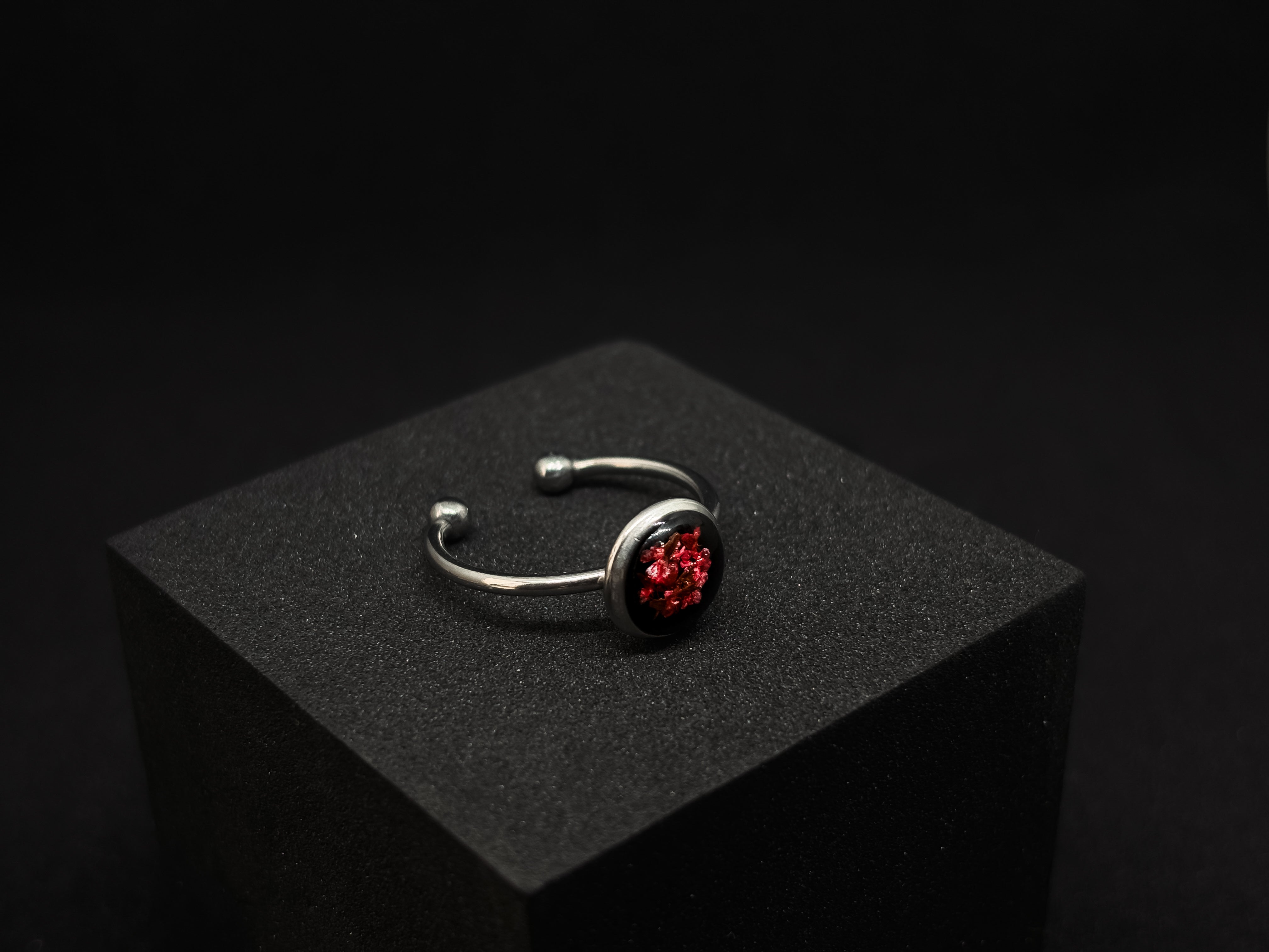 Sterling silver adjustable ring with a deep red floral resin inlay